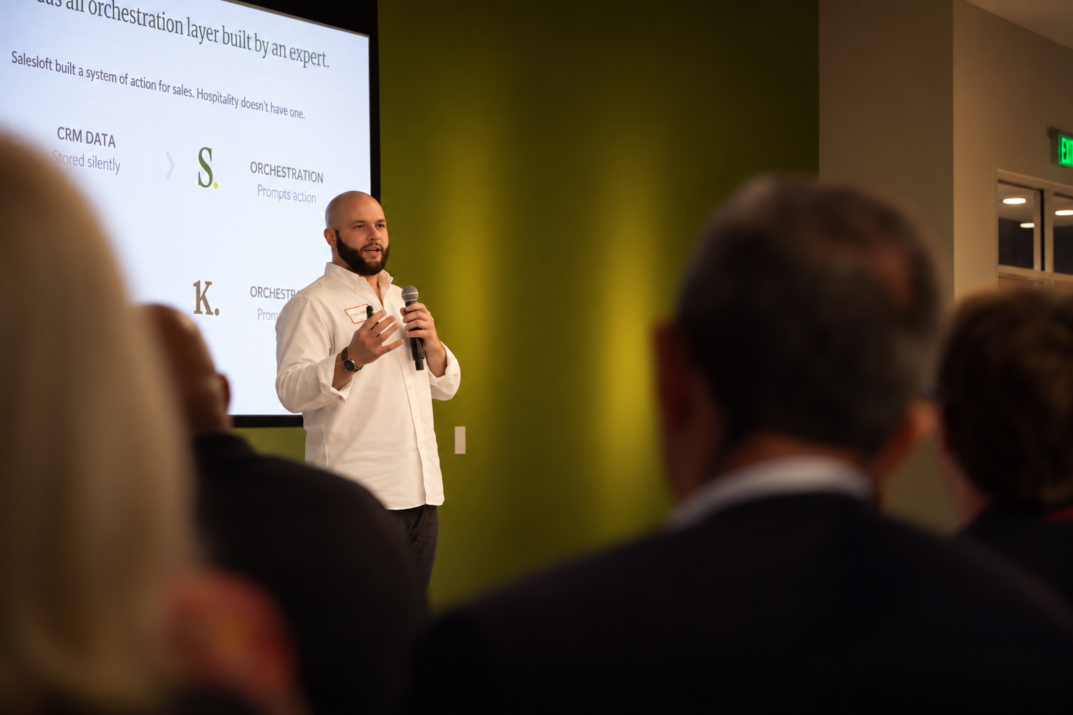 Knownly founder David Leibell presenting at Launchpad Tech Ventures Demo Day, beside a slide comparing Salesloft's system of action for sales with hospitality's missing orchestration layer
